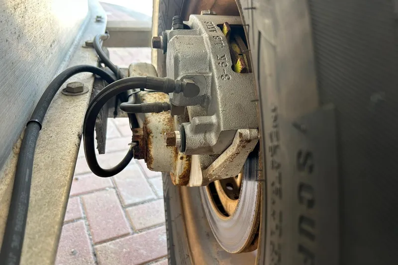 Slide: The Image of Close-up of a 2019 Sea Hunt Gamefish 27 trailer brake system and tire. - 16