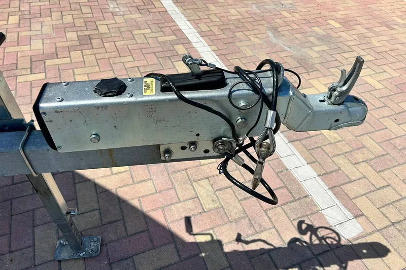 Slide: The Image of Trailer hitch of a 2019 Sea Hunt Gamefish 27 boat on brick pavement. - 19
