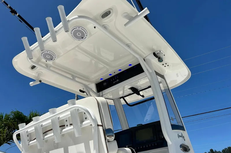 Slide: The Image of 2019 Sea Hunt Gamefish 27 boat with forward seating, featuring rod holders and speakers. - 23