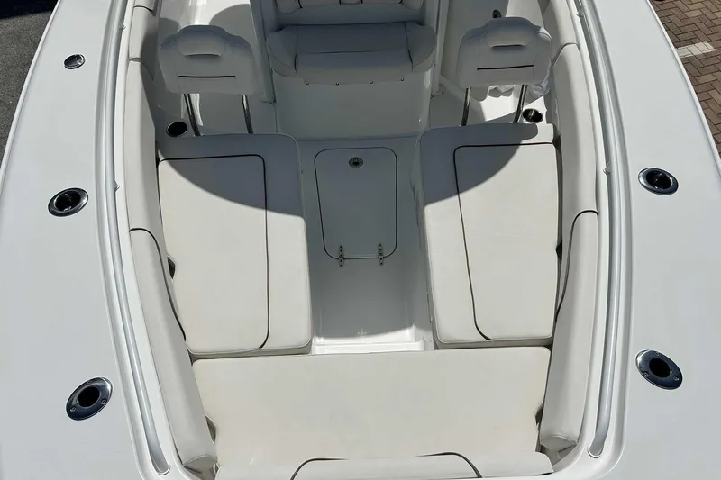Slide: The Image of 2019 Sea Hunt Gamefish 27 Forward Seating, spacious white interior with cushioned seats. - 25