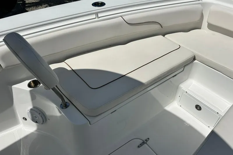 Slide: The Image of 2019 Sea Hunt Gamefish 27 Forward Seating, featuring comfortable white cushioned seats and storage compartments. - 26