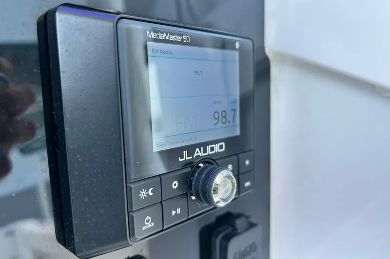 Slide: The Image of JL Audio MediaMaster 50 on 2019 Sea Hunt Gamefish 27, displaying FM radio frequency 98.7. - 38