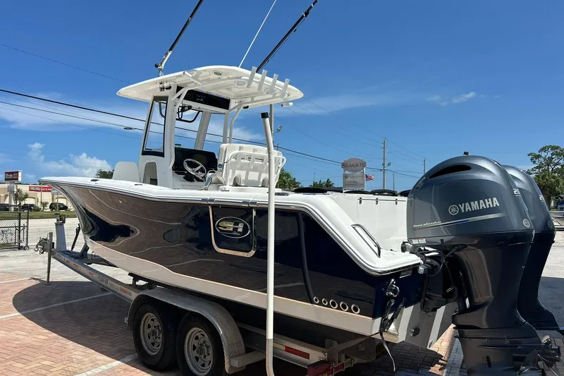 Slide: The Image of 2019 Sea Hunt Gamefish 27 boat with Yamaha engines on a trailer. - 4
