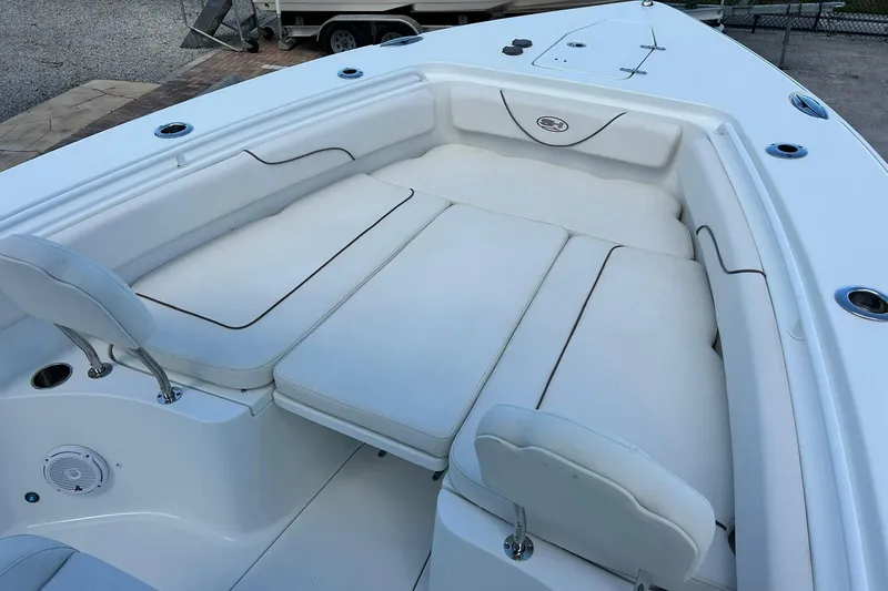 Slide: The Image of 2019 Sea Hunt Gamefish 27 Forward Seating, white cushioned boat interior. - 40