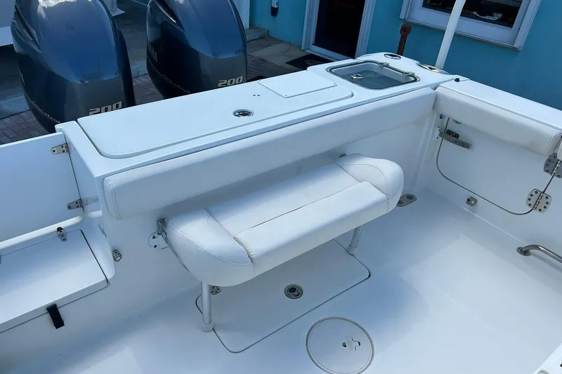 Slide: The Image of 2019 Sea Hunt Gamefish 27 boat interior with seating and dual Yamaha 200 engines. - 43