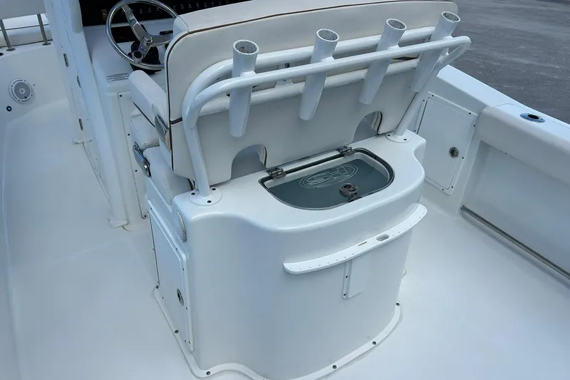 Slide: The Image of 2019 Sea Hunt Gamefish 27 boat interior with rod holders and seating. - 47