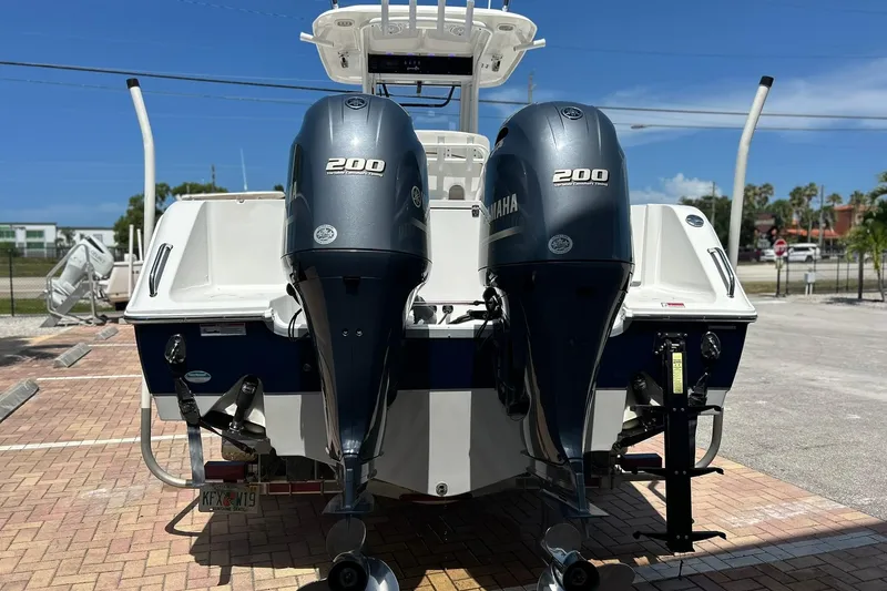 Slide: The Image of 2019 Sea Hunt Gamefish 27 with twin Yamaha 200 engines, parked on a sunny day. - 5