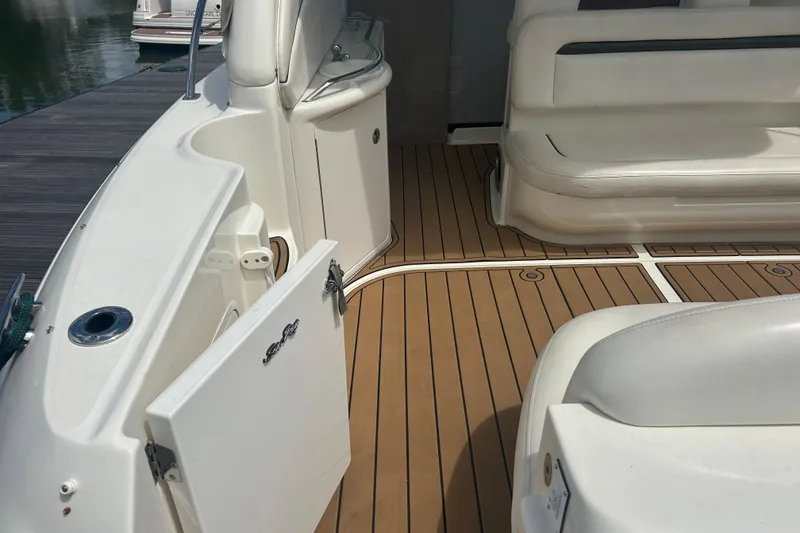 Slide: The Image of 2005 Sea Ray 360 Sundancer boat interior with teak flooring and white seating. - 11
