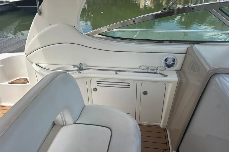 Slide: The Image of 2005 Sea Ray 360 Sundancer interior with white seating and storage compartments. - 14