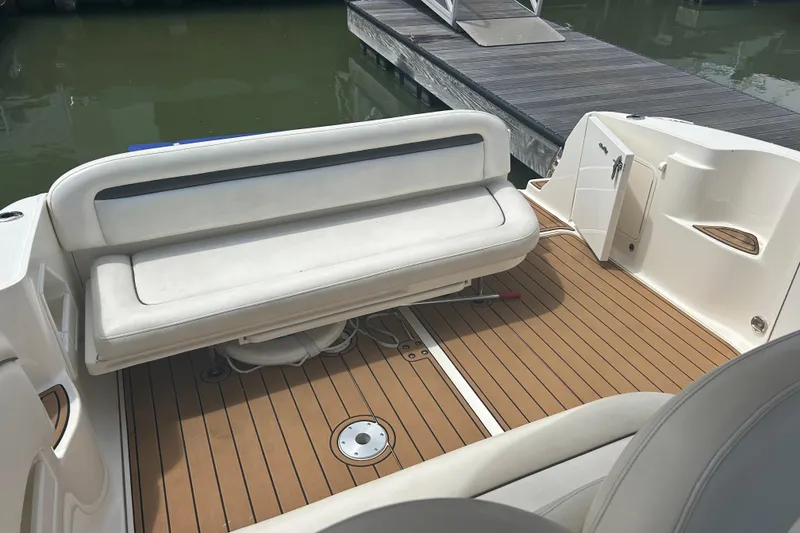 Slide: The Image of 2005 Sea Ray 360 Sundancer boat interior with white seating and teak flooring. - 15