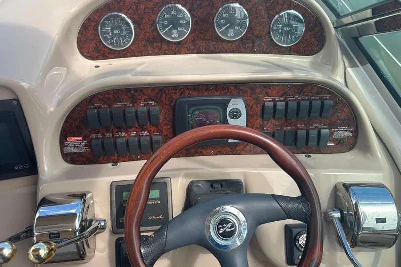 Slide: The Image of Control panel of a 2005 Sea Ray 360 Sundancer boat with gauges and switches. - 17