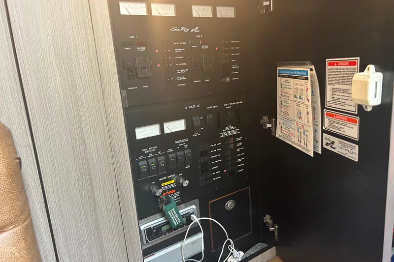 Slide: The Image of Electrical control panel of a 2005 Sea Ray 360 Sundancer boat, featuring switches and gauges. - 18
