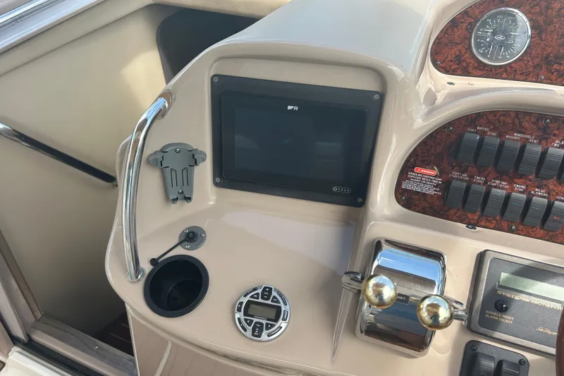 Slide: The Image of Control panel of a 2005 Sea Ray 360 Sundancer boat, featuring navigation and system controls. - 20