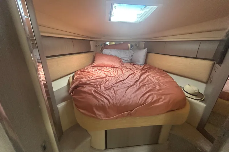 Slide: The Image of Cozy cabin interior of 2005 Sea Ray 360 Sundancer with skylight and plush bedding. - 29
