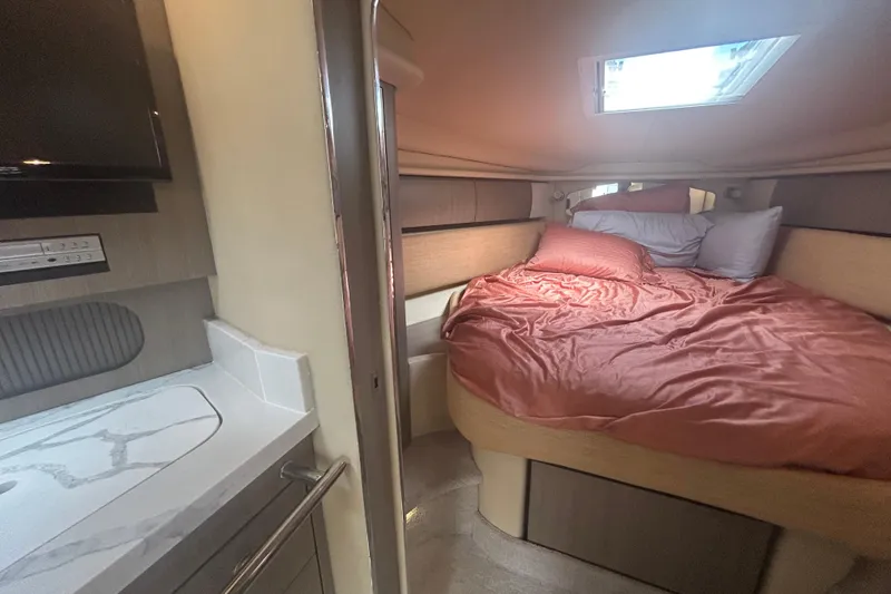 Slide: The Image of 2005 Sea Ray 360 Sundancer cabin with cozy bed and modern amenities. - 30