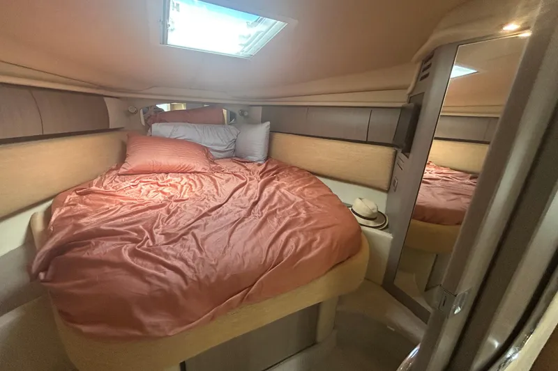 Slide: The Image of Cozy cabin interior of 2005 Sea Ray 360 Sundancer with bed and mirror. - 32