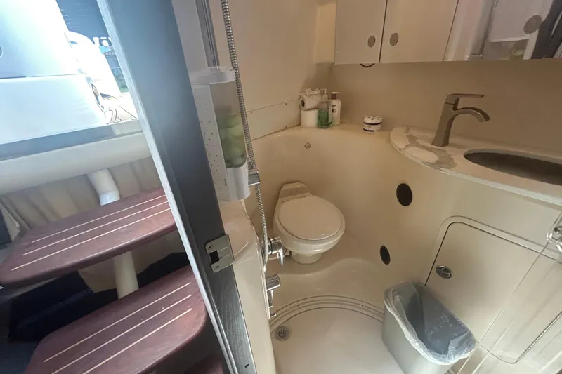 Slide: The Image of 2005 Sea Ray 360 Sundancer bathroom interior with sink, toilet, and storage cabinets. - 37