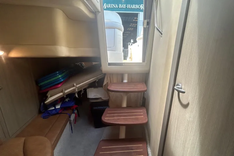 Slide: The Image of Interior of 2005 Sea Ray 360 Sundancer with wooden steps and storage area. - 40