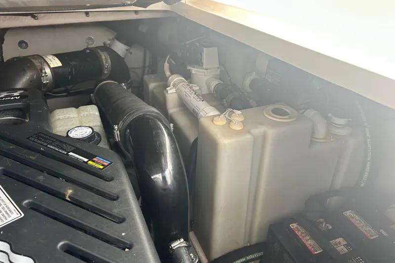 Slide: The Image of Engine compartment of a 2005 Sea Ray 360 Sundancer, showing various components and hoses. - 44
