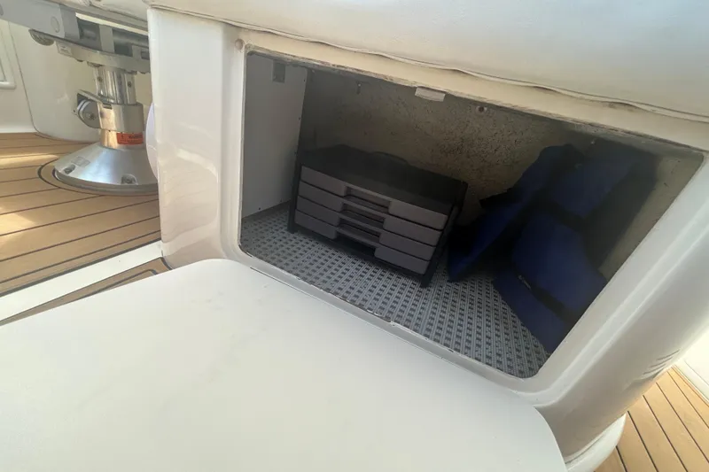 Slide: The Image of Storage compartment on 2005 Sea Ray 360 Sundancer boat with life jackets and tackle box. - 49