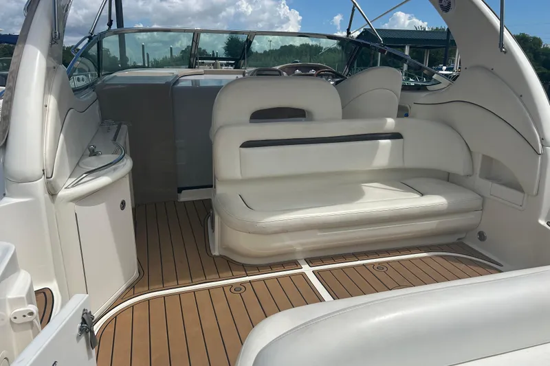 Slide: The Image of 2005 Sea Ray 360 Sundancer interior with white seating and teak flooring. - 9