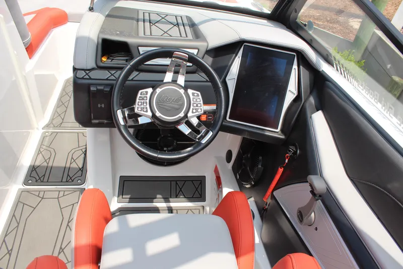 Slide: The Image of 2020 Tigé 23ZX boat dashboard with steering wheel and touchscreen display. - 7