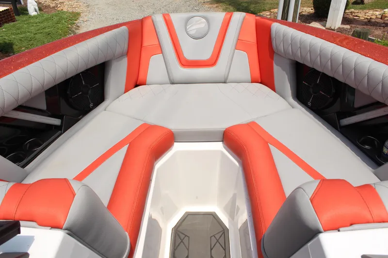 Slide: The Image of 2020 Tigé 23ZX boat interior with orange and gray seating, featuring modern design and speakers. - 8