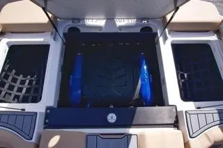 Slide: The Image of 2025 MasterCraft XT20 boat interior storage compartments with blue accents. - 15