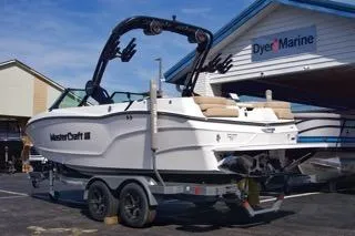 Slide: The Image of 2025 MasterCraft XT20 boat on trailer at Dyer Marine dealership. - 2
