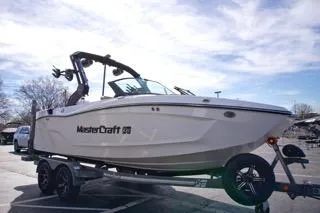 Slide: The Image of 2025 MasterCraft XT20 boat on trailer under blue sky. - 5