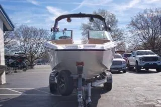 Slide: The Image of 2025 MasterCraft XT20 boat on trailer in parking lot, sunny day. - 6