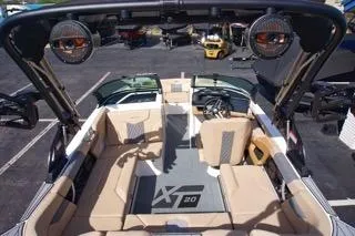 Slide: The Image of 2025 MasterCraft XT20 boat interior with beige seating and advanced audio system. - 7