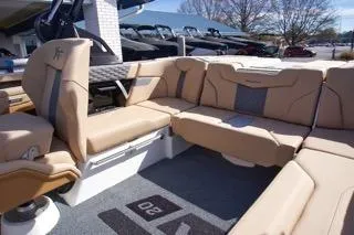 Slide: The Image of 2025 MasterCraft XT20 boat interior with beige seating and modern design. - 9