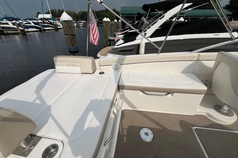 Slide: The Image of 2013 Sea Ray 280 Sundeck interior with seating, docked at marina. - 12