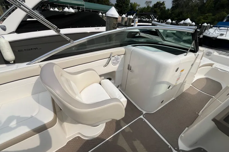 Slide: The Image of 2013 Sea Ray 280 Sundeck interior with white seating and sleek design. - 16