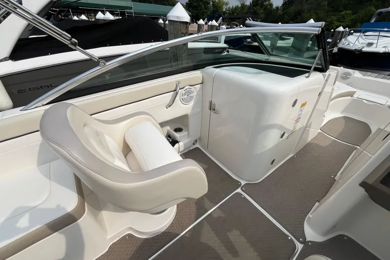 Slide: The Image of 2013 Sea Ray 280 Sundeck interior with beige seating and sleek design. - 17
