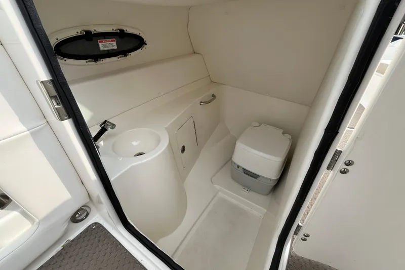 Slide: The Image of 2013 Sea Ray 280 Sundeck boat bathroom with sink and portable toilet. - 18