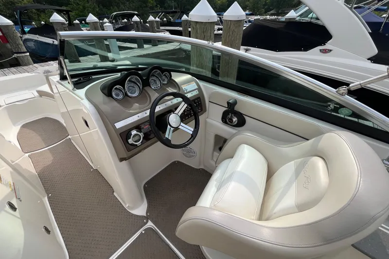 Slide: The Image of 2013 Sea Ray 280 Sundeck boat interior with steering wheel and dashboard controls. - 19