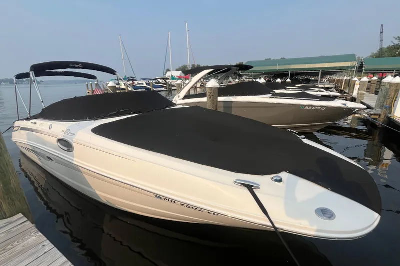 Slide: The Image of 2013 Sea Ray 280 Sundeck boat docked at marina, covered and ready for use. - 2