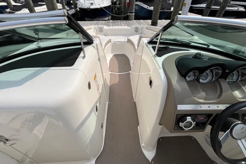 Slide: The Image of 2013 Sea Ray 280 Sundeck interior with dashboard and seating area, docked at marina. - 24