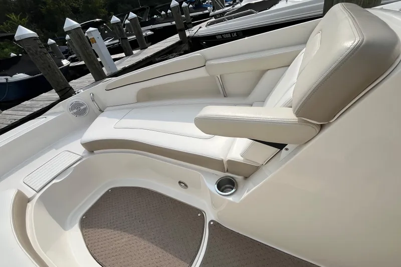 Slide: The Image of 2013 Sea Ray 280 Sundeck interior with beige seating and cup holder, docked at marina. - 29