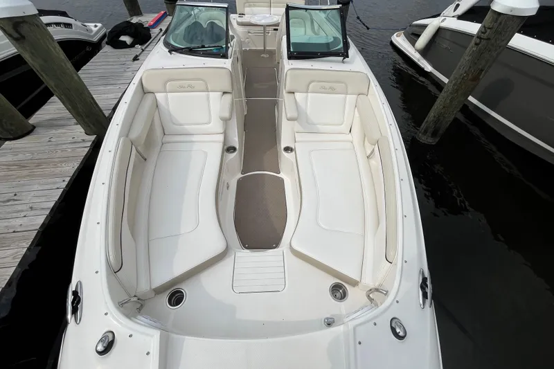 Slide: The Image of 2013 Sea Ray 280 Sundeck boat interior with white seating and open deck layout. - 36
