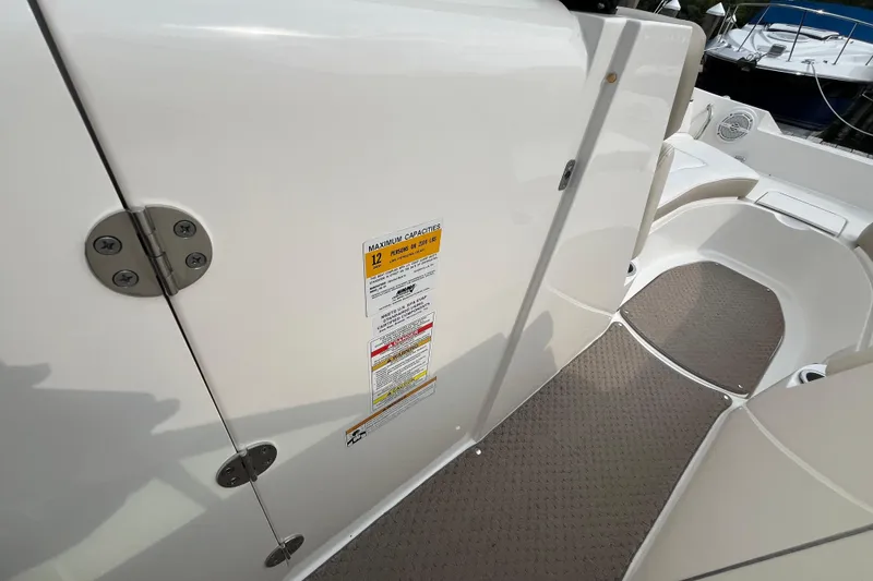 Slide: The Image of 2013 Sea Ray 280 Sundeck interior with capacity label and seating area. - 38