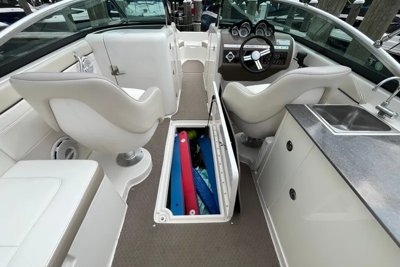 Slide: The Image of 2013 Sea Ray 280 Sundeck interior with storage, seating, and sink. - 39