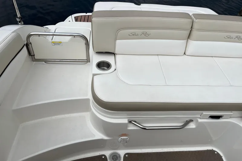 Slide: The Image of 2013 Sea Ray 280 Sundeck boat seating area with cup holder and safety gate. - 40