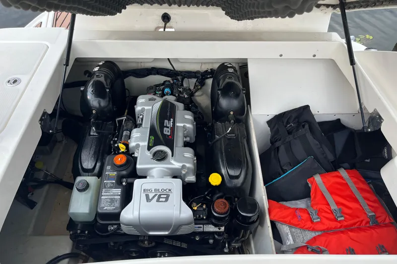 Slide: The Image of 2013 Sea Ray 280 Sundeck engine compartment with V8 engine and life jackets. - 41