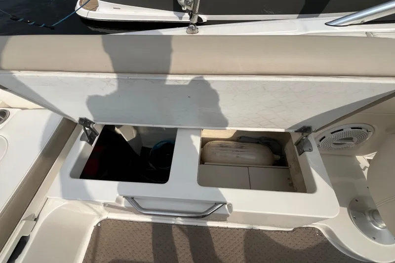 Slide: The Image of Open storage compartment on a 2013 Sea Ray 280 Sundeck boat, revealing interior space. - 43