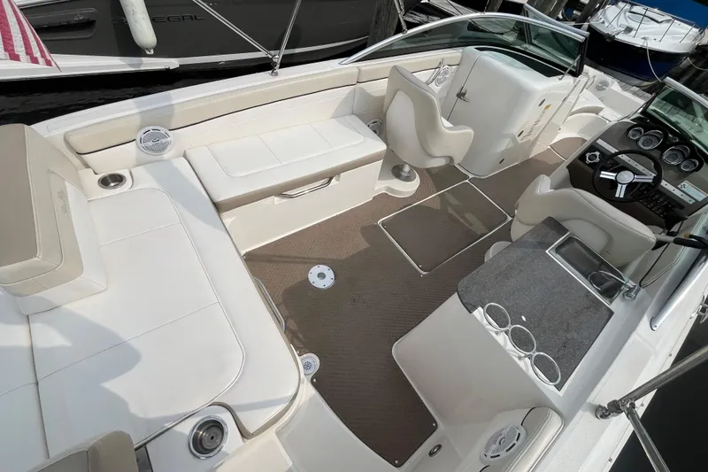 Slide: The Image of 2013 Sea Ray 280 Sundeck interior with white seating and modern dashboard. - 6