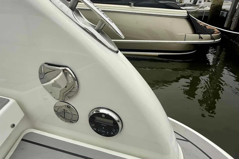 Slide: The Image of 2020 Formula 290 Bowrider boat detail, docked near another vessel, showcasing sleek design. - 11