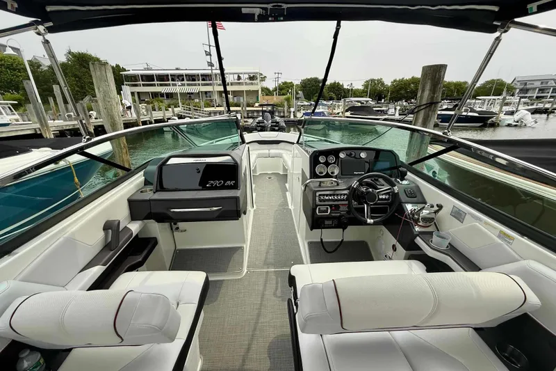 Slide: The Image of 2020 Formula 290 Bowrider interior, featuring sleek design and modern controls at a marina. - 12